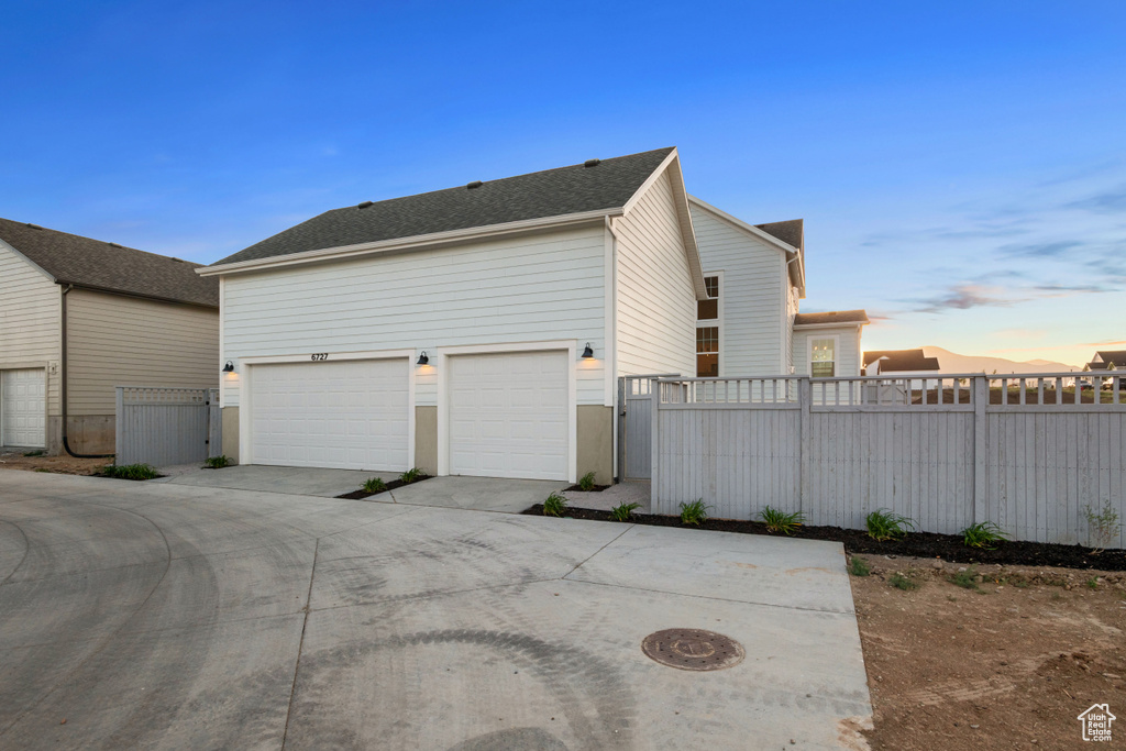 Property exterior at dusk featuring driveway