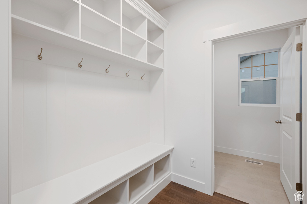 Mudroom with baseboards and dark wood-style flooring