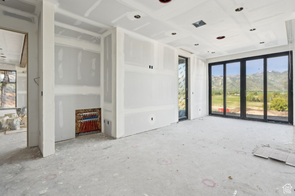 Unfurnished living room featuring a mountain view