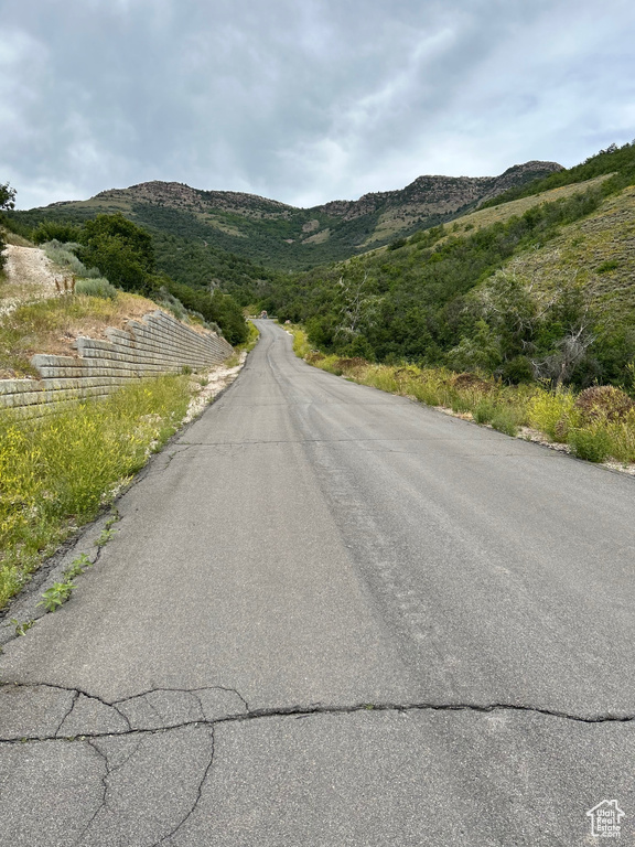 View of asphalt street featuring a mountain view