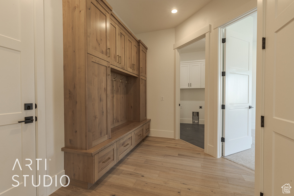 Mudroom with light hardwood / wood-style flooring