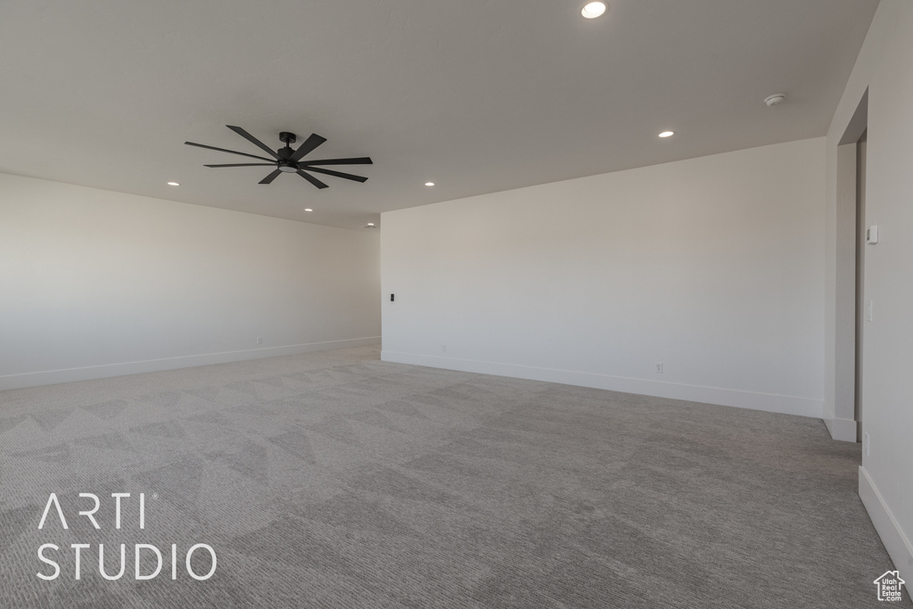 Carpeted empty room featuring ceiling fan