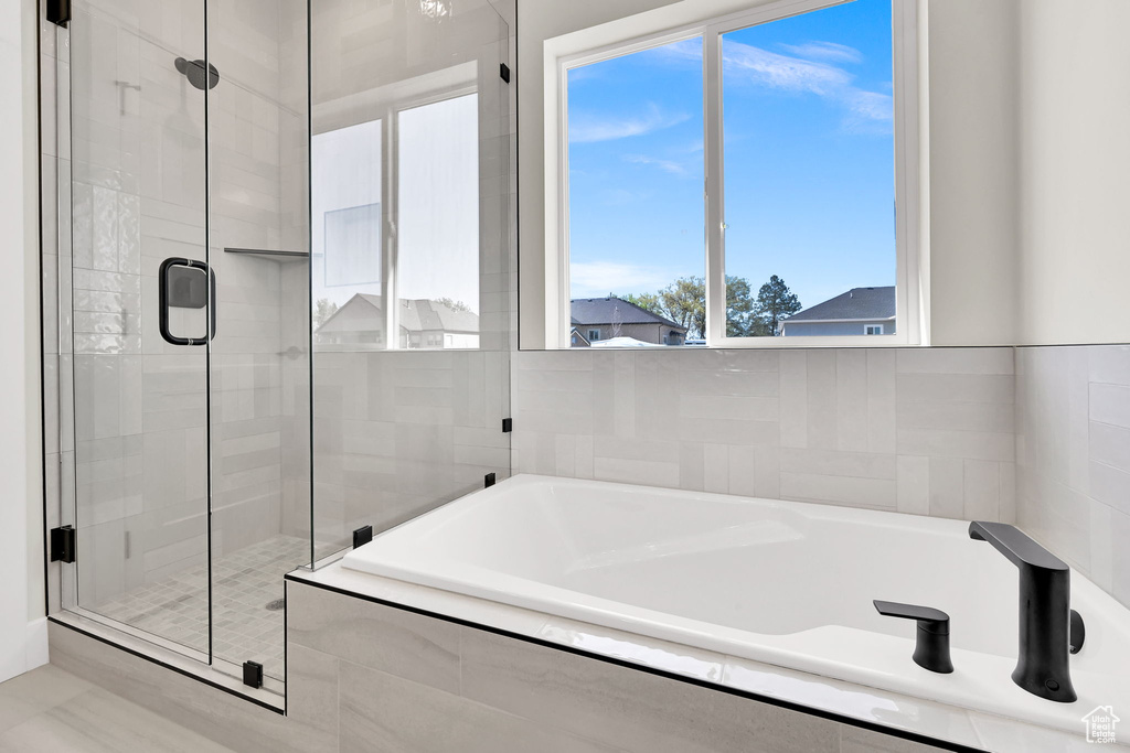 Full bath with a shower stall and a garden tub