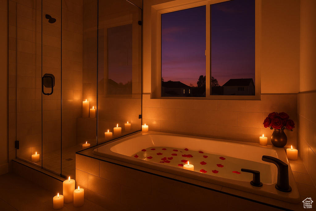 Full bath featuring a garden tub and a shower stall