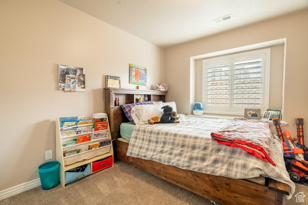 Bedroom featuring visible vents, carpet floors, and baseboards