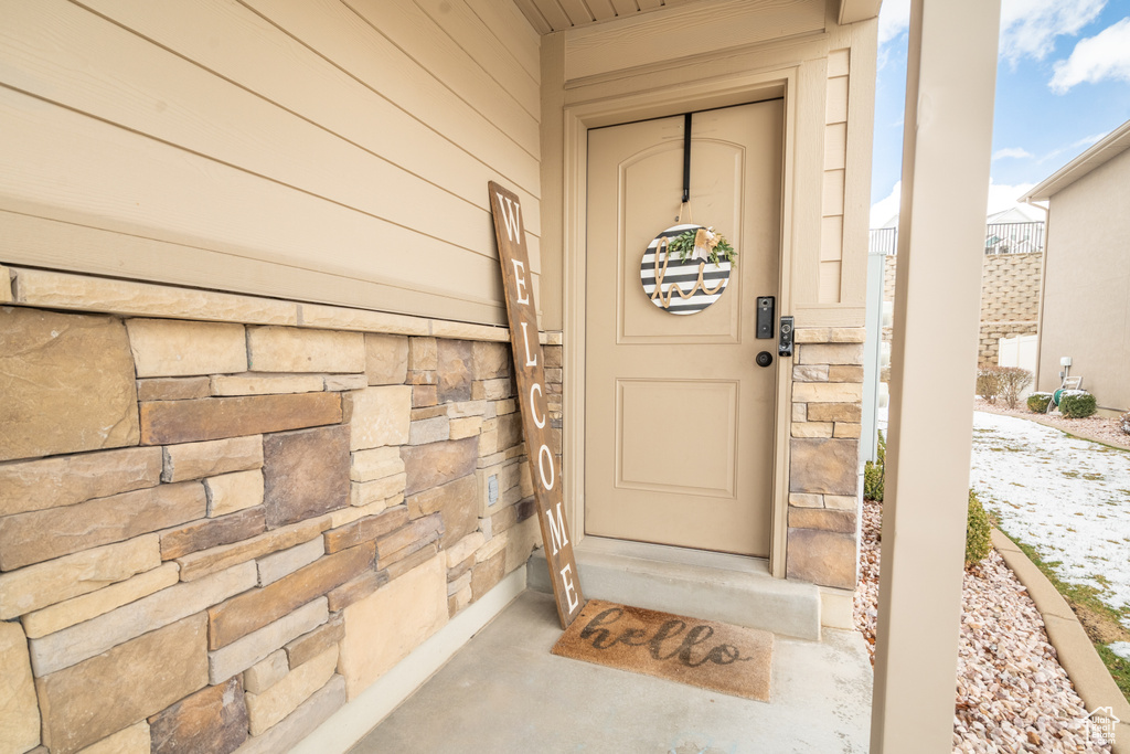 View of exterior entry with stone siding