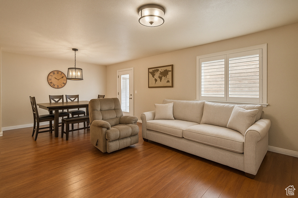 Living room featuring wood finished floors, baseboards, and plenty of natural light
