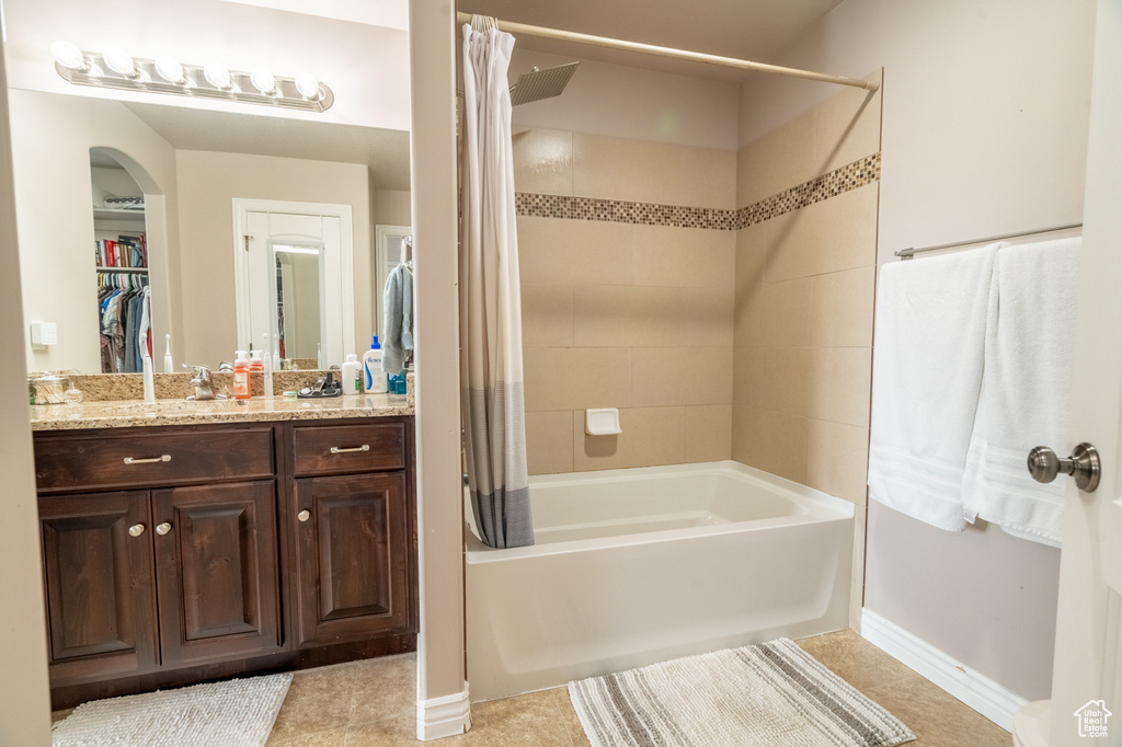 Bathroom with vanity, tile patterned floors, and shower / bath combo
