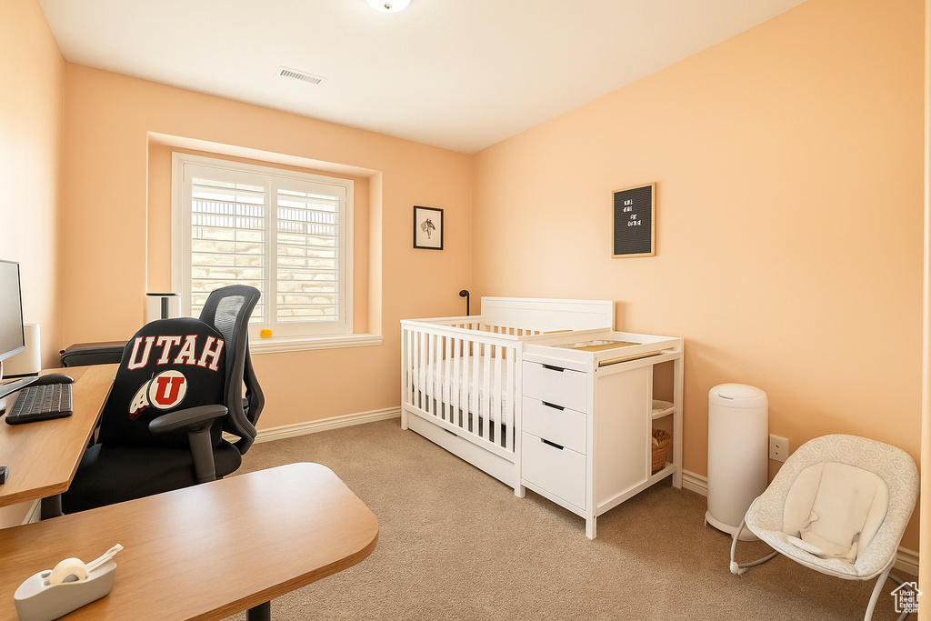 Bedroom featuring carpet, an office area, and baseboards
