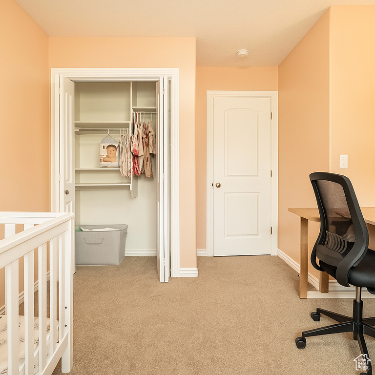 Bedroom featuring carpet flooring, a closet, baseboards, and an office area