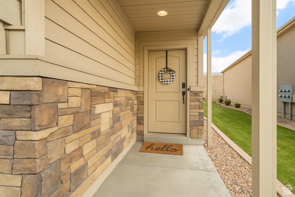 Entrance to property with stone siding
