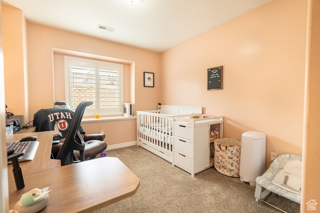 Bedroom with light carpet, visible vents, and baseboards