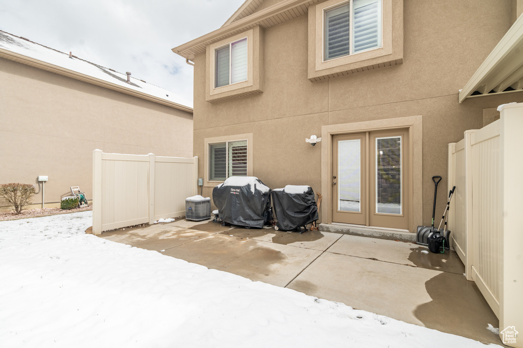 Rear view of house with stucco siding, a patio, and fence