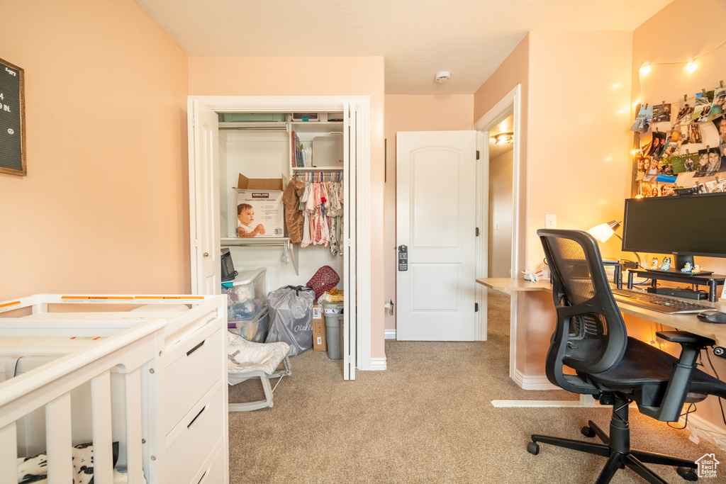Office space featuring baseboards and light carpet