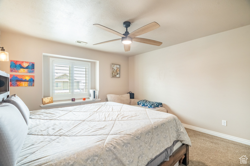 Bedroom featuring visible vents, ceiling fan, baseboards, and carpet floors