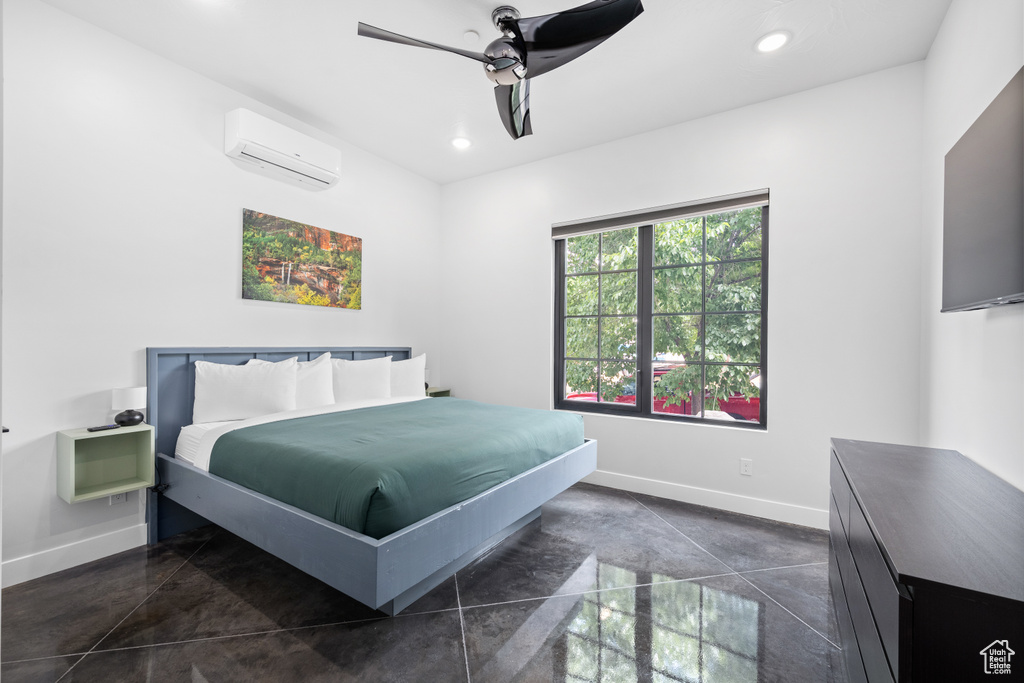 Bedroom featuring ceiling fan and a wall unit AC