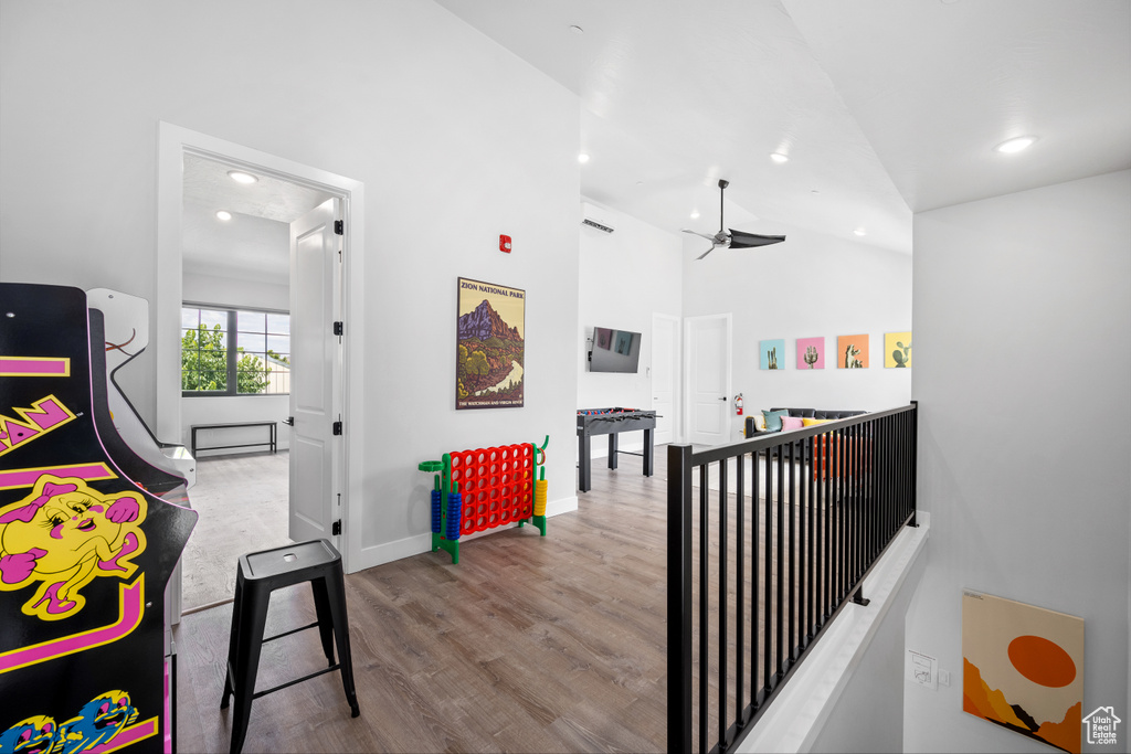 Corridor featuring light hardwood / wood-style floors and vaulted ceiling