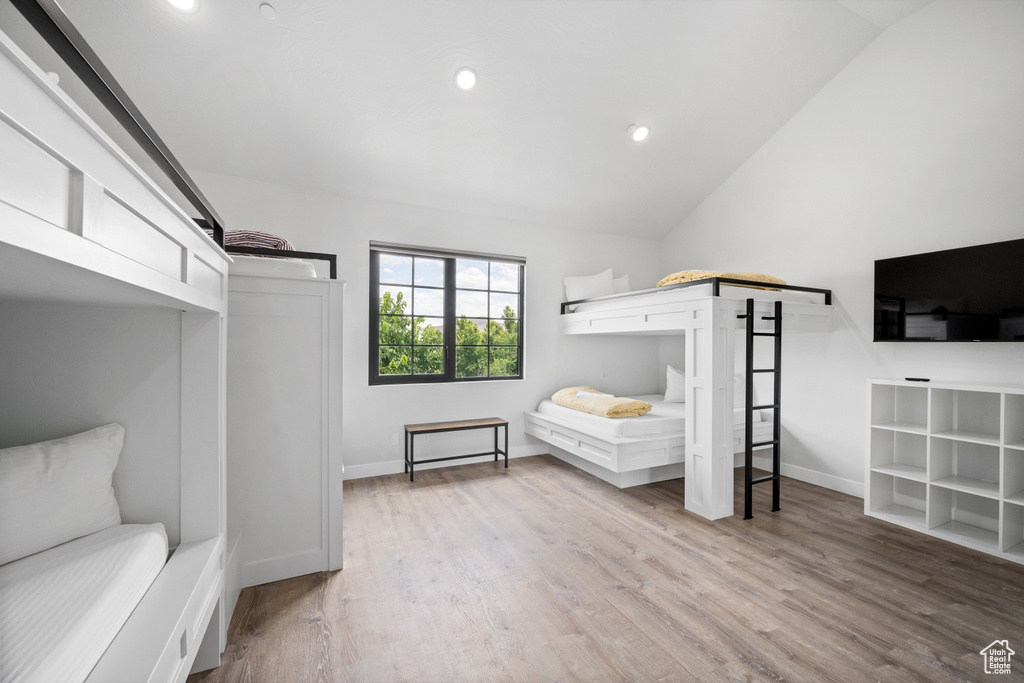 Bedroom featuring lofted ceiling and light wood-type flooring