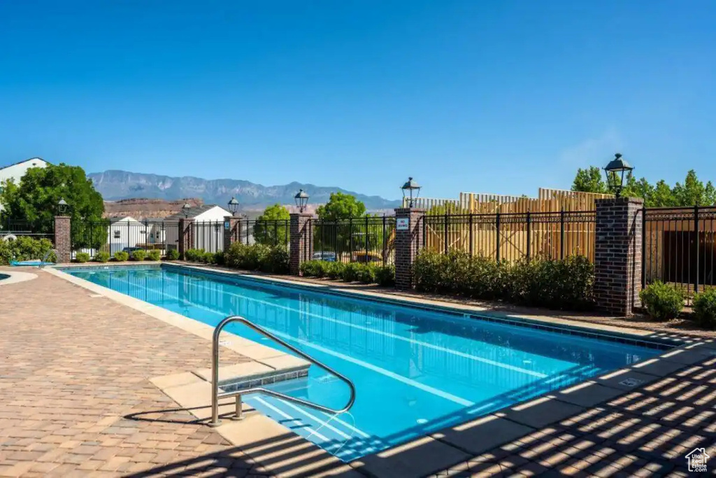 View of swimming pool featuring a mountain view and a patio area