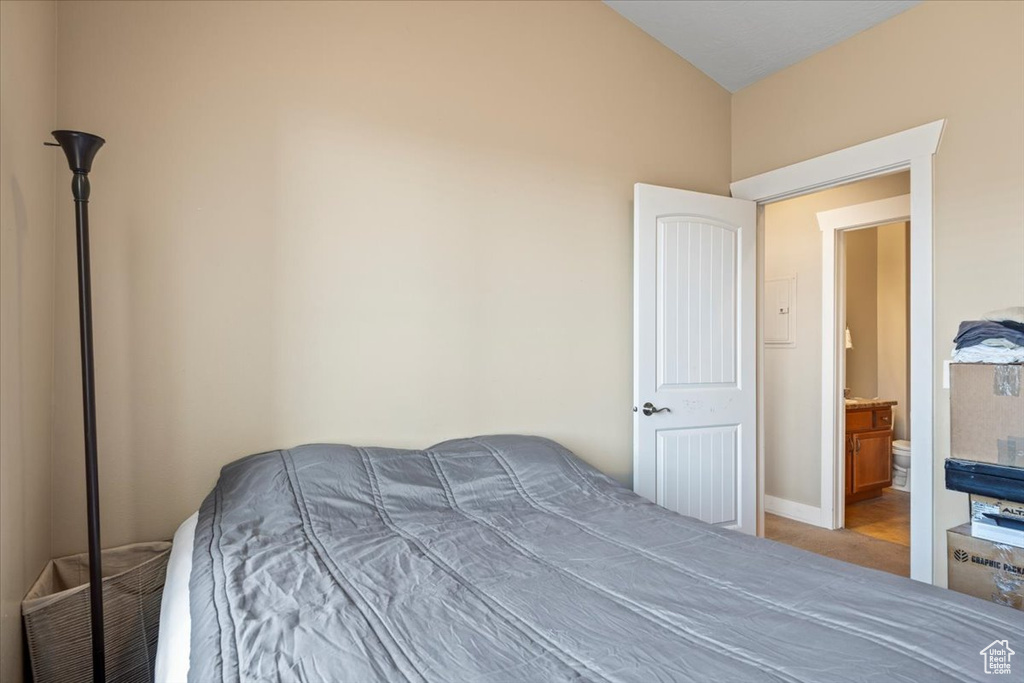 Bedroom with vaulted ceiling and connected bathroom