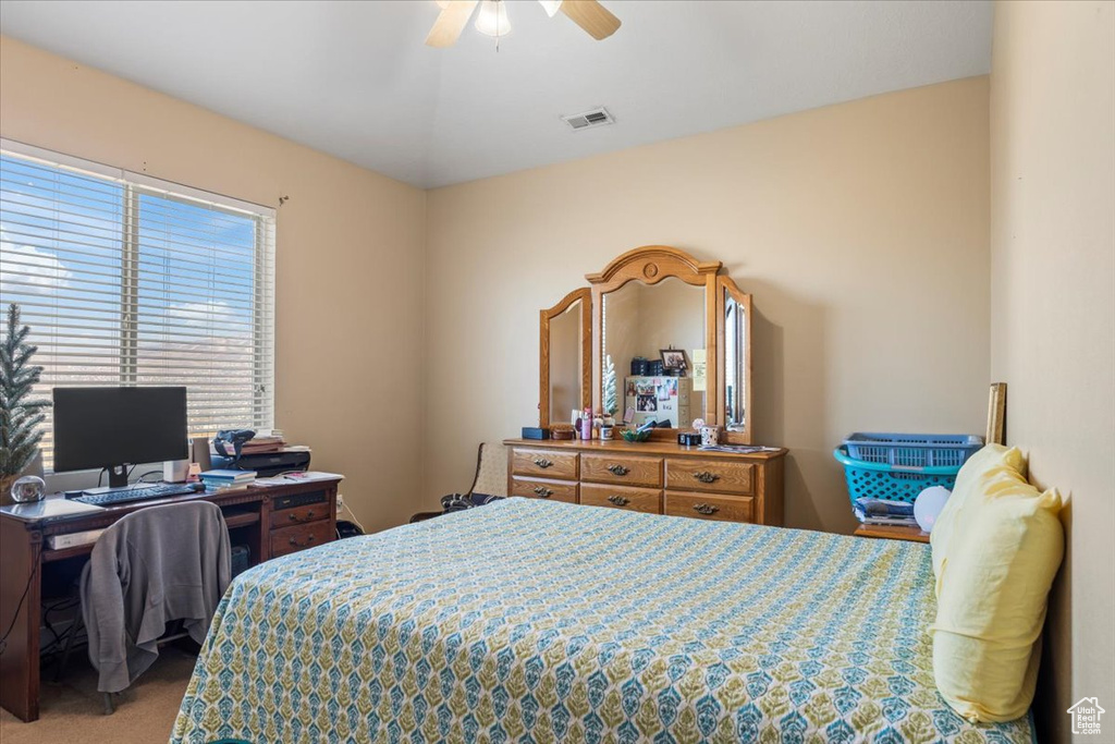 Carpeted bedroom with ceiling fan