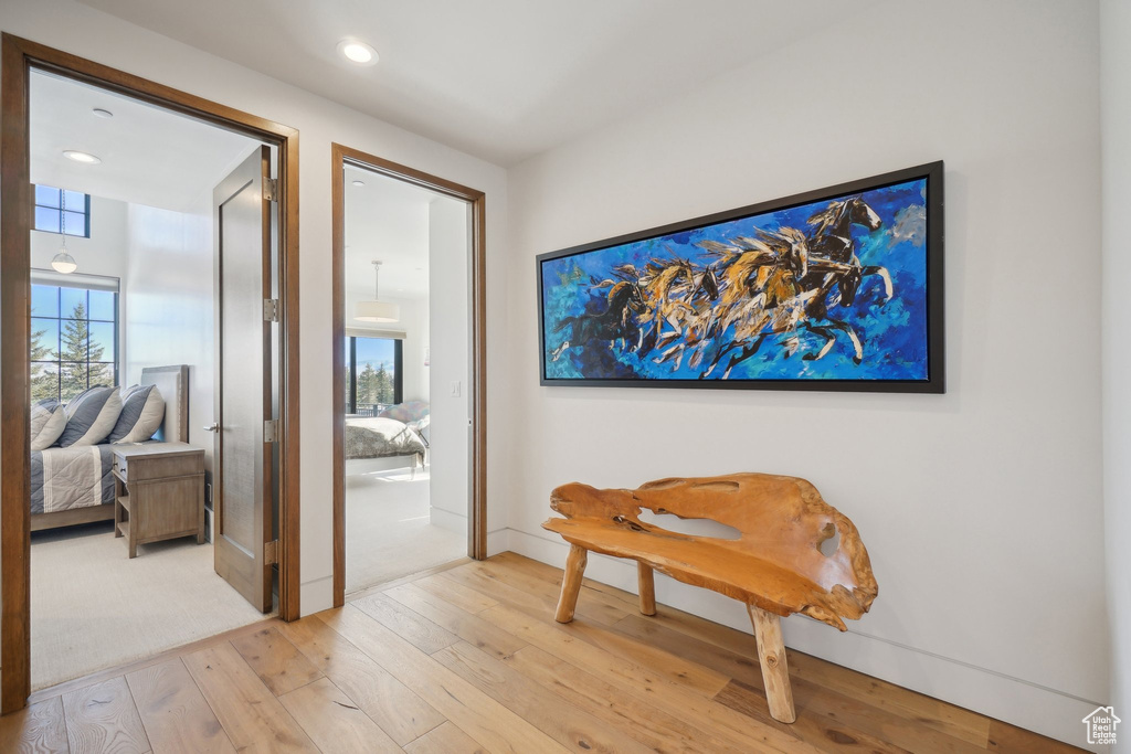Corridor featuring light wood-style floors, baseboards, and recessed lighting