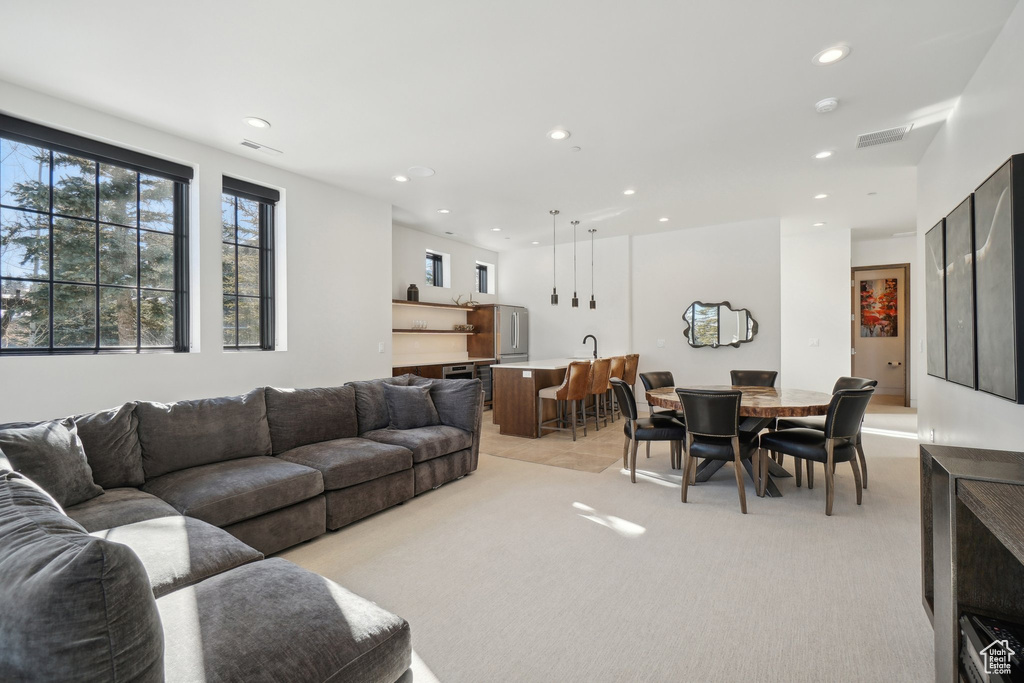 Living room with light carpet and recessed lighting