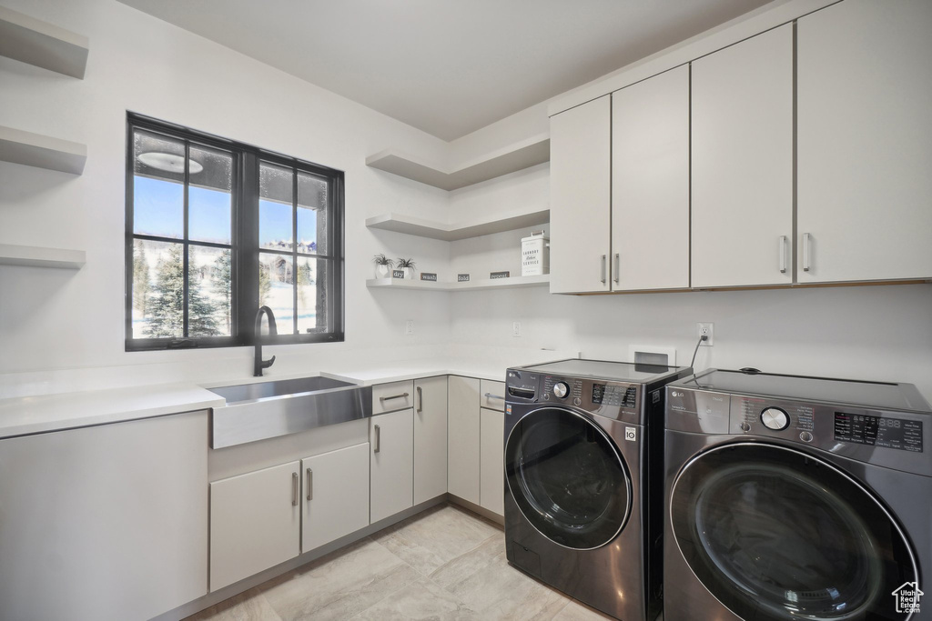 Washroom with washer and dryer and cabinet space