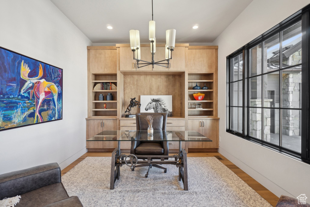 Home office featuring a chandelier, wood finished floors, baseboards, and recessed lighting