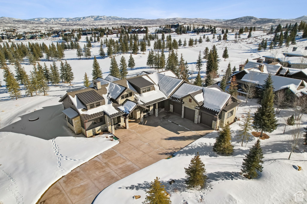 Snowy aerial view with a mountain view and a residential view