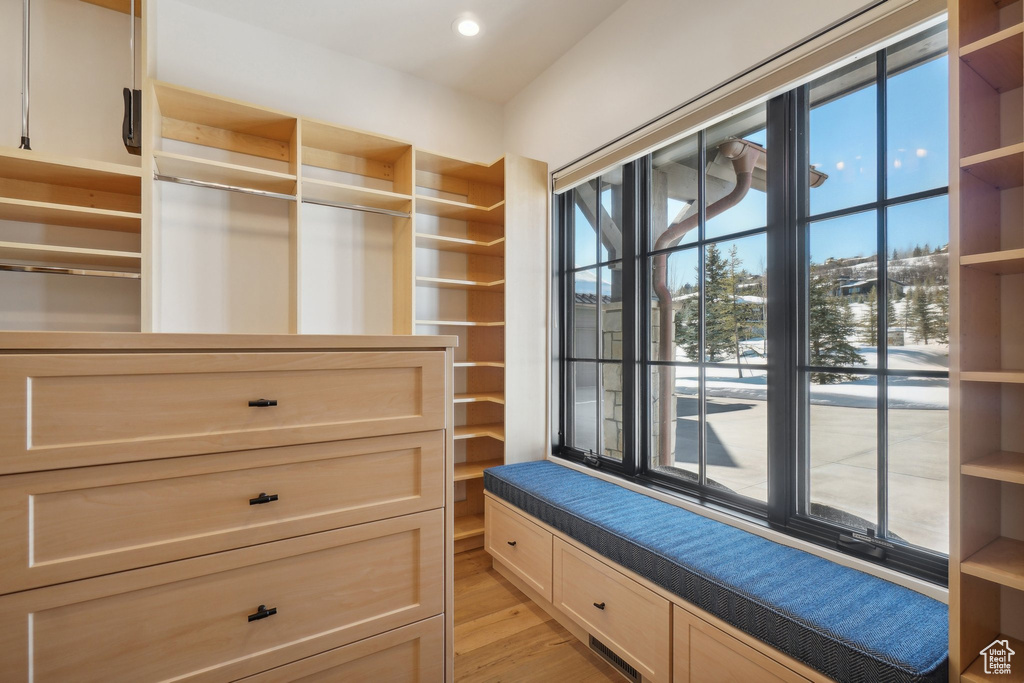 Spacious closet with light wood finished floors