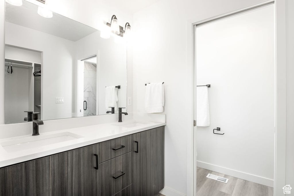 Bathroom featuring vanity and hardwood / wood-style floors