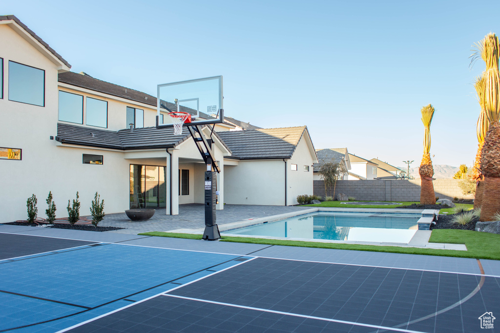 View of sport court featuring a fenced in pool