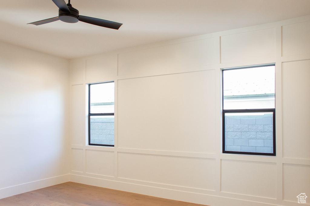 Spare room featuring hardwood / wood-style flooring and ceiling fan