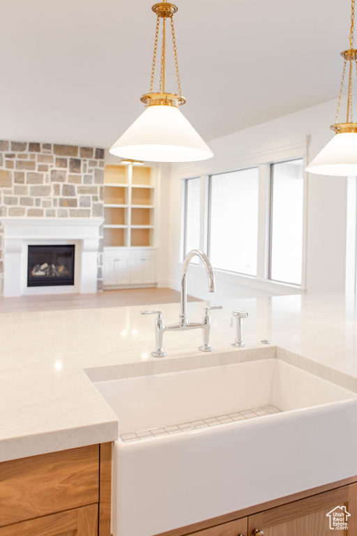 Kitchen featuring hanging light fixtures and sink