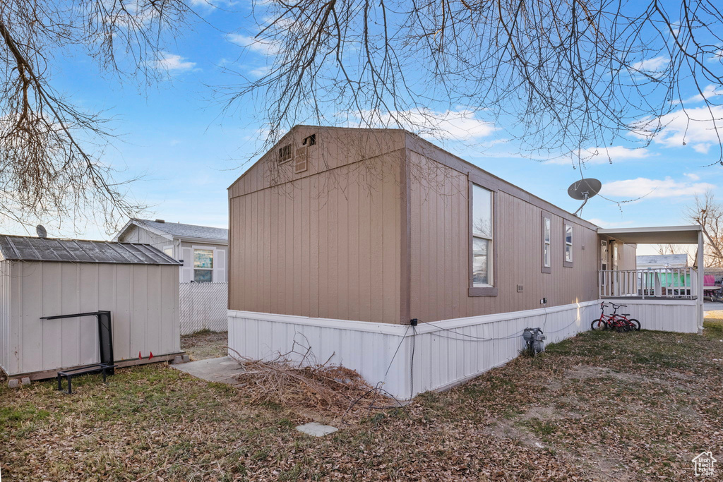 View of property exterior with a shed