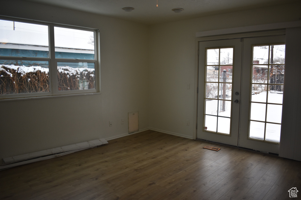 Spare room featuring french doors and dark hardwood / wood-style floors