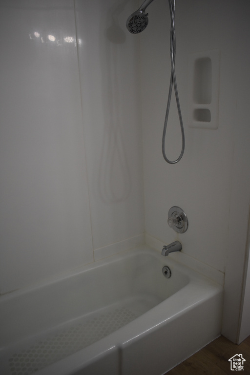 Bathroom featuring hardwood / wood-style floors and bathtub / shower combination