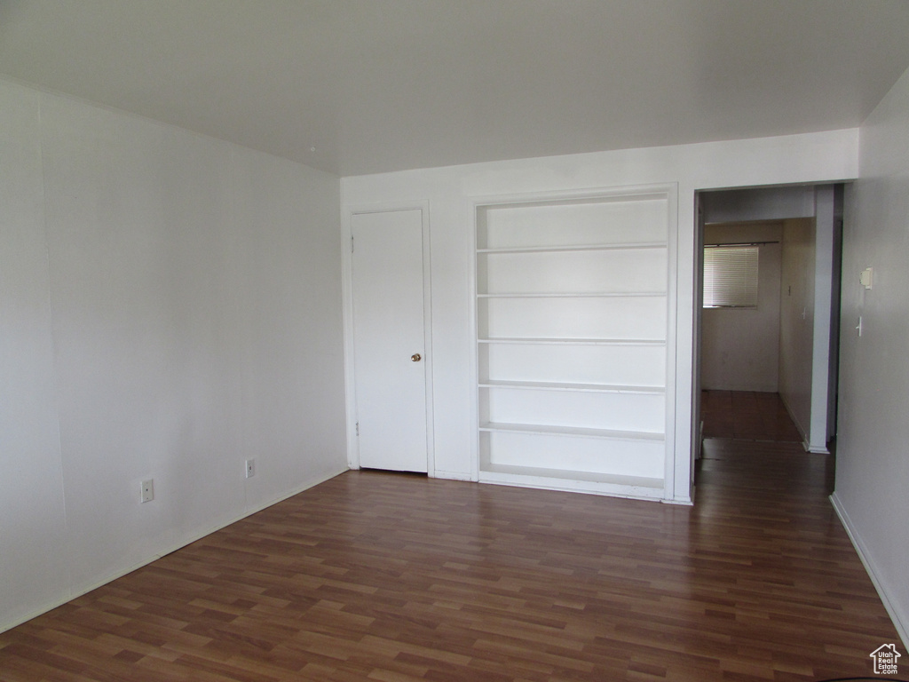 Unfurnished bedroom with a closet and dark hardwood / wood-style flooring