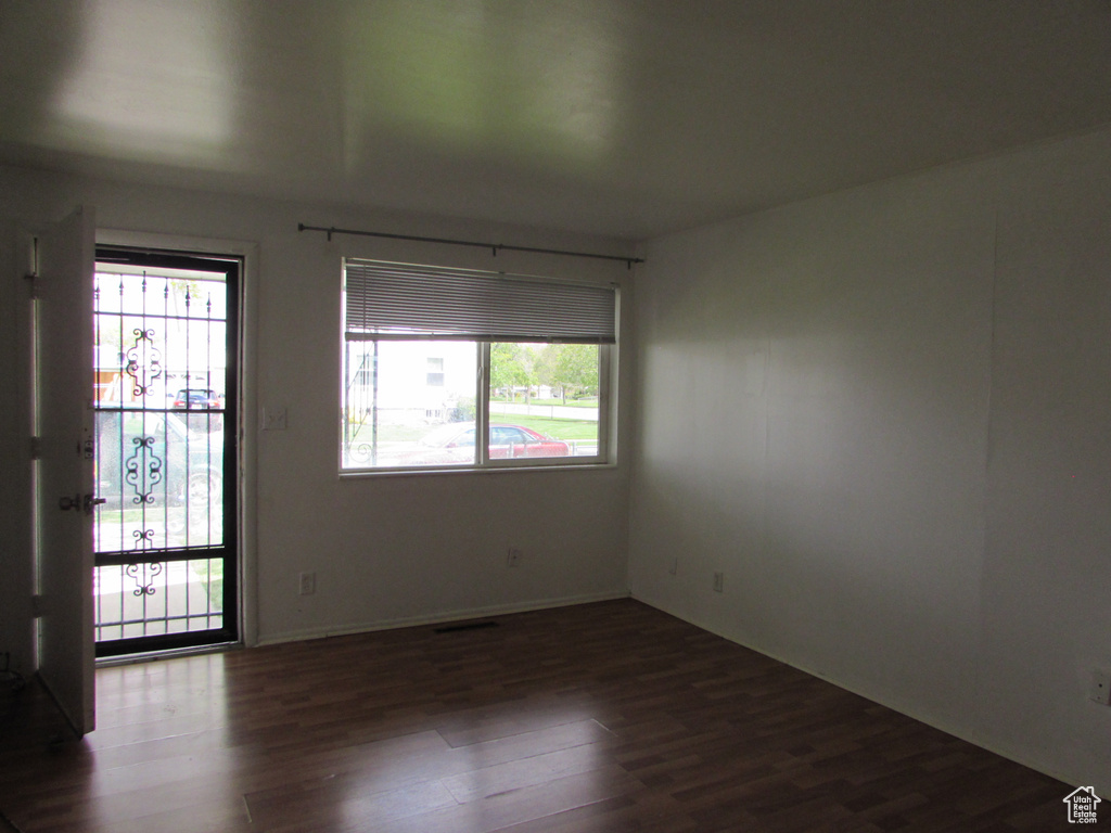 Empty room with dark wood-type flooring