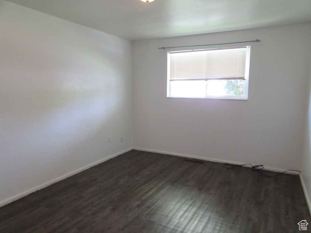 Unfurnished room featuring dark hardwood / wood-style flooring