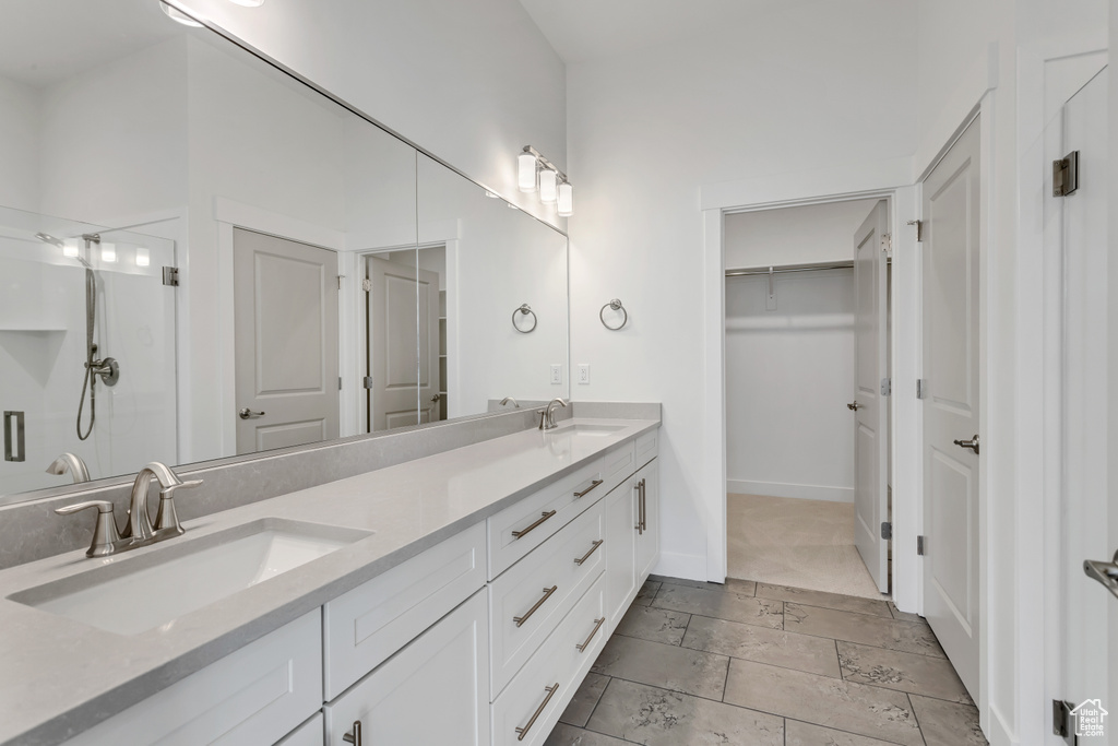 Bathroom featuring a shower and vanity