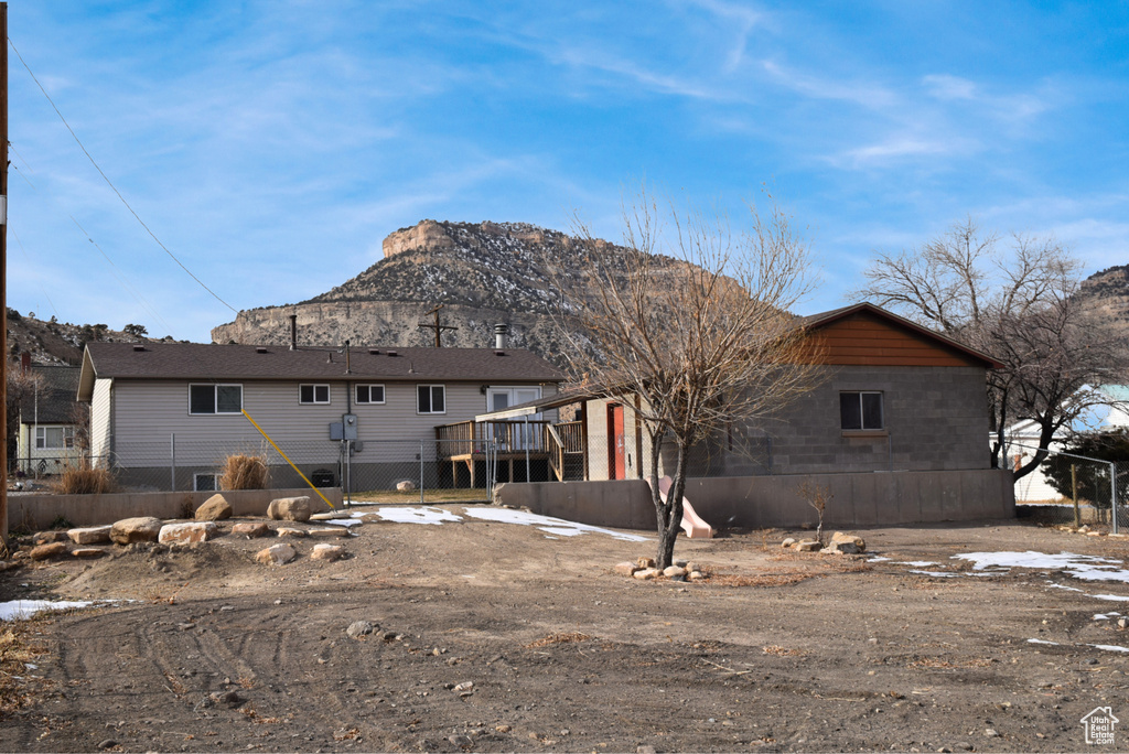 Rear view of house featuring a deck with mountain view