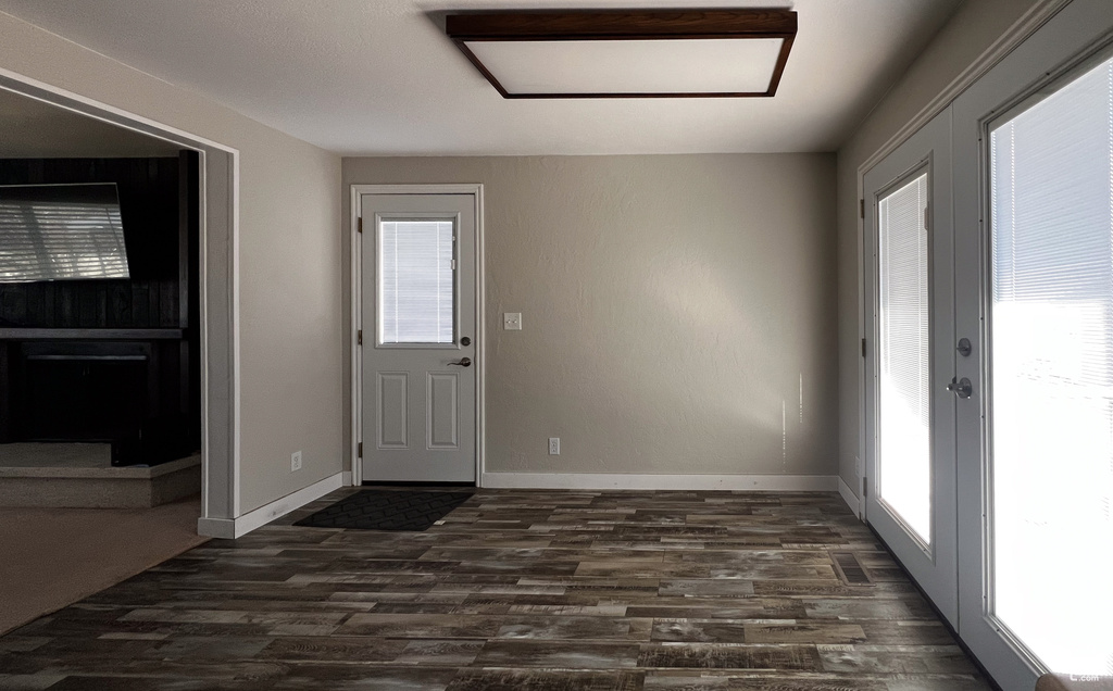 Entrance foyer featuring french doors and dark hardwood / wood-style flooring