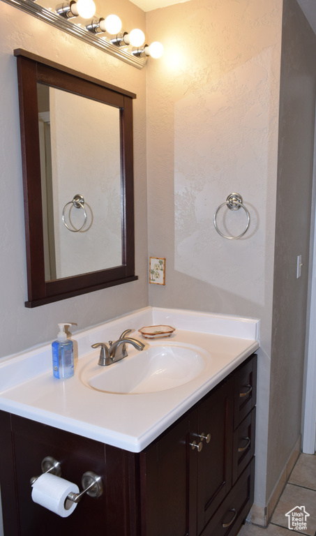 Bathroom featuring vanity and tile patterned flooring