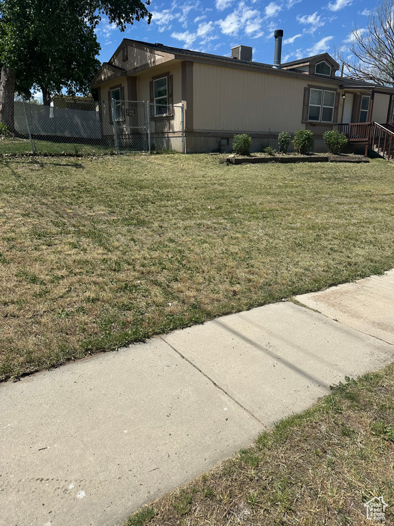 View of side of home with central AC