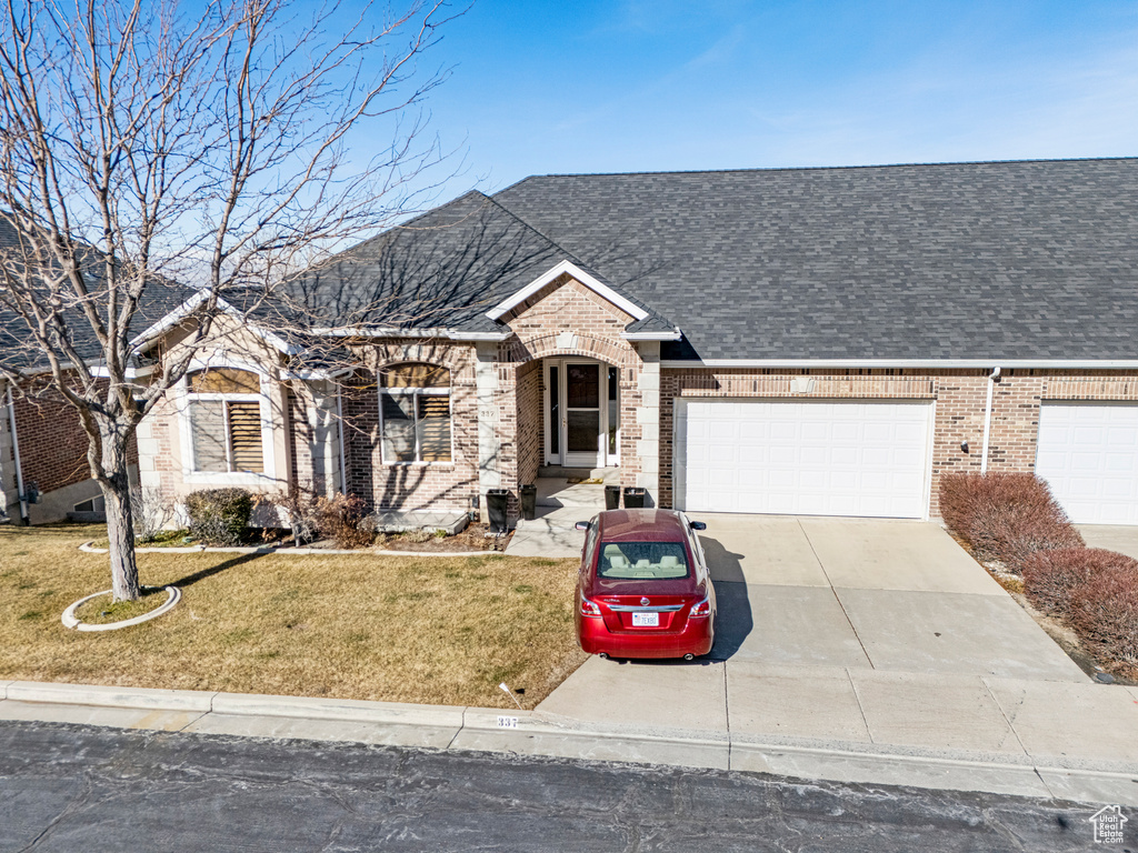 Ranch-style house with a garage and a front yard