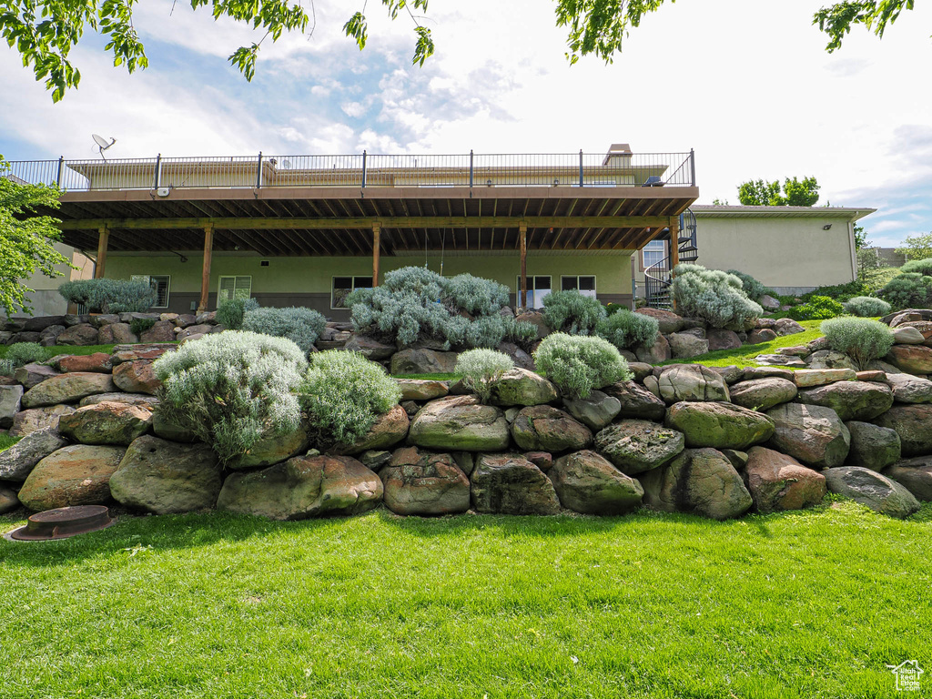 Back of property with a lawn and a deck
