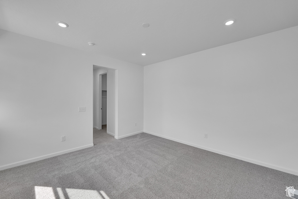 Carpeted empty room with recessed lighting, baseboards, and a smoke detector