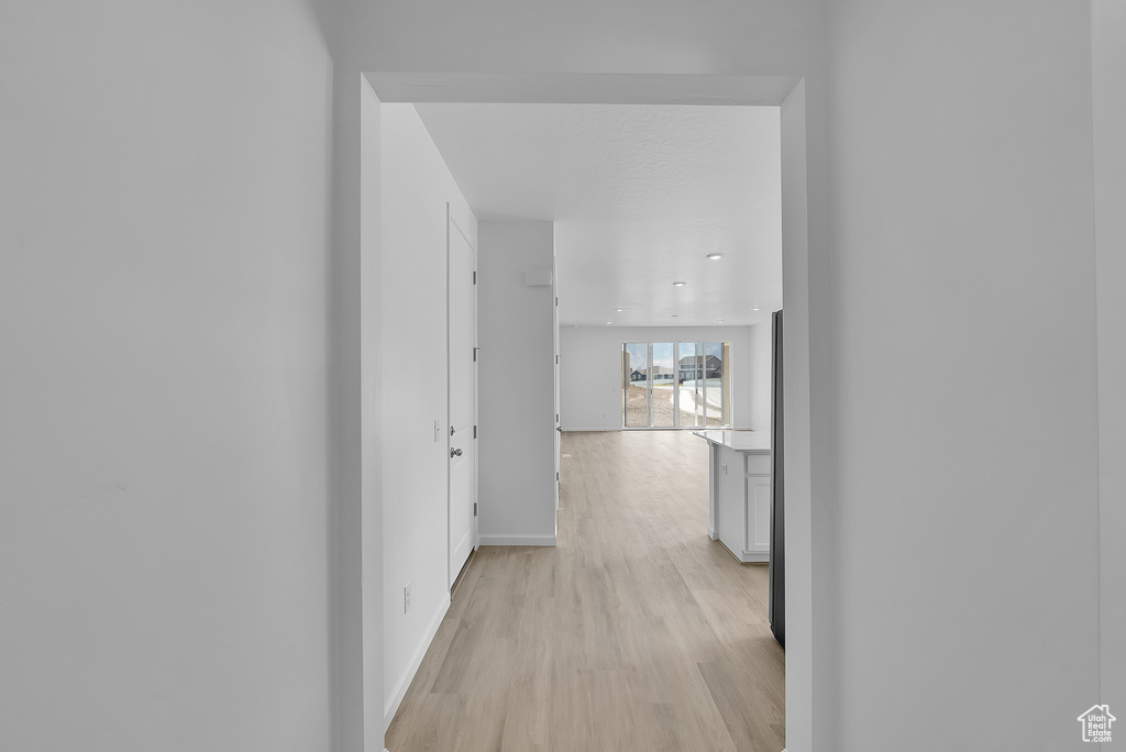 Hall featuring light wood-style floors and baseboards